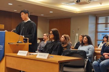 Kelvin Lau, Law’24, presents his team’s argument while his co-counsel and classmate Nillab Hassani looks on at the Grand Moot held in the Moot Courtroom on Sept. 29. 