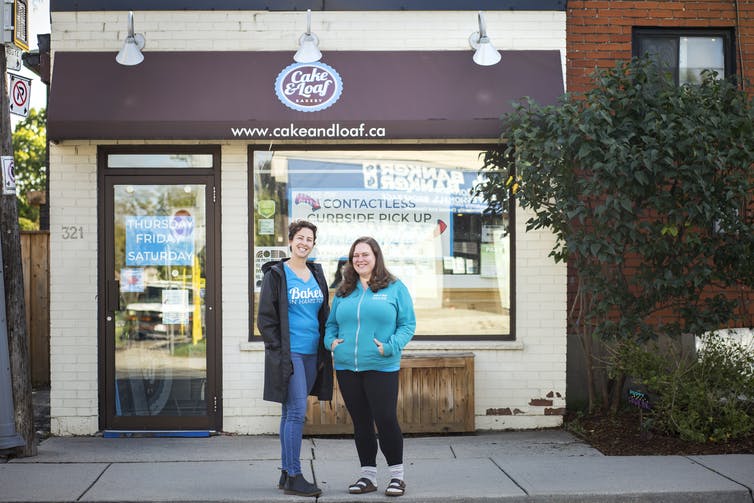 The co-owners of a bakery in Hamilton, Ont., pose outside of their store in October 2020. (THE CANADIAN PRESS/Tara Walton)