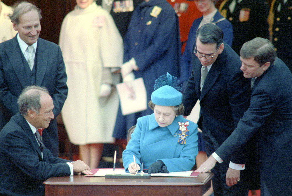 Prime Minister Trudeau and Queen Elizabeth II sign the Constitution of Canada, 1982. 