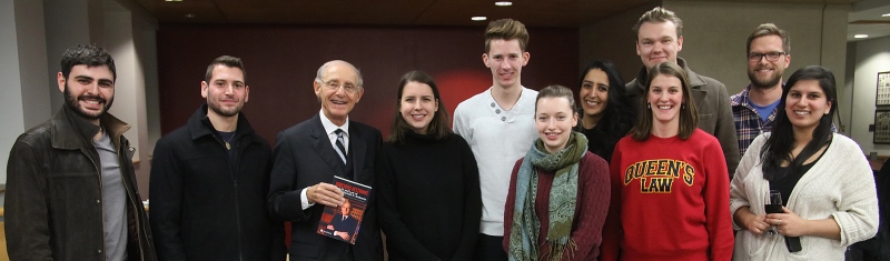 Justice Marshall Rothstein, retired from the Supreme Court of Canada, poses with students in Macdonald Hall after his book launch on February 9. (Photo by Bernard Clark)