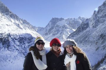 three students in snowy mountains