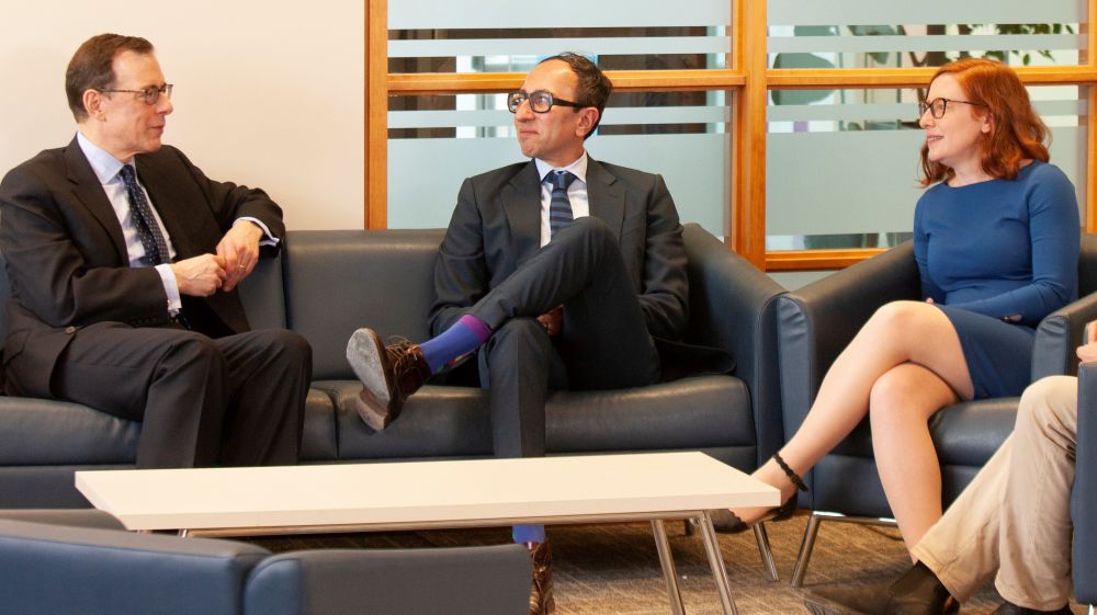 Professor Robert Yalden, left, discusses taxation with professors Mohamed Khimji, centre, and Gail Henderson, right.