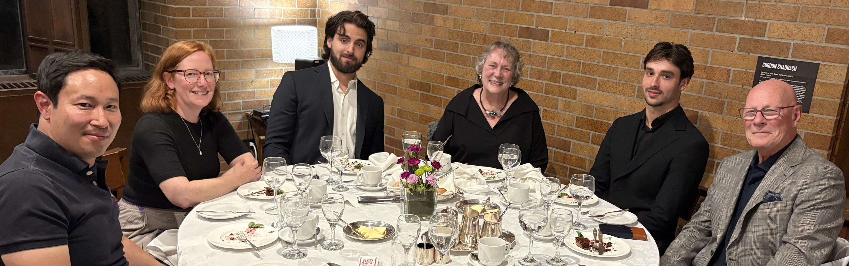 Queen’s Law professors and symposium co-organizers Ivan Ozai and Gail Henderson at the symposium dinner with four members of Art Cockfield’s family: son Jack, mother Gale, son William, and stepfather Eric Costen.