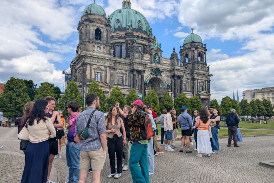 A photo of students standing in front of s historic copper-domed building
