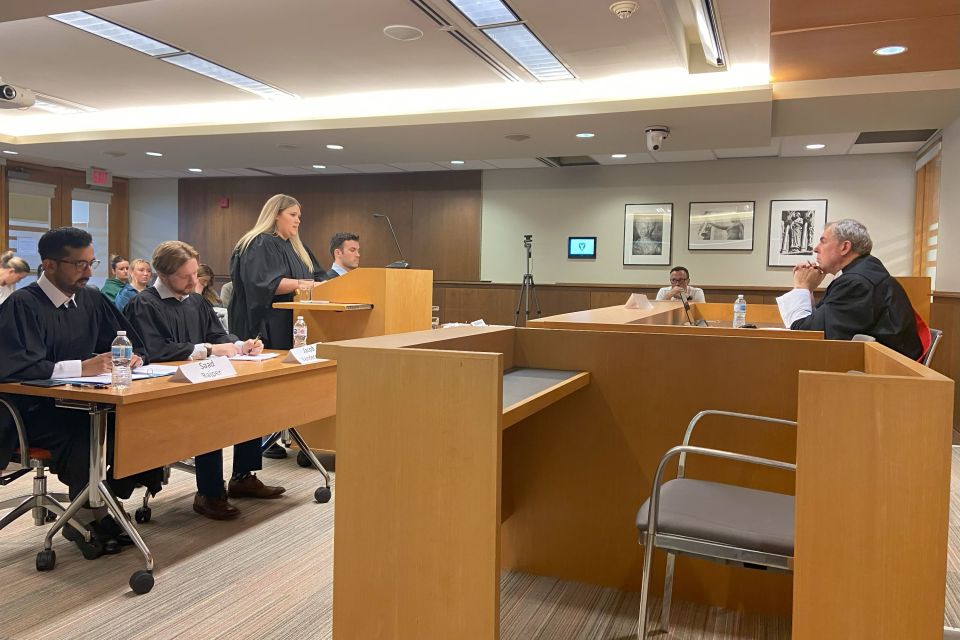 Several people participate in a moot court