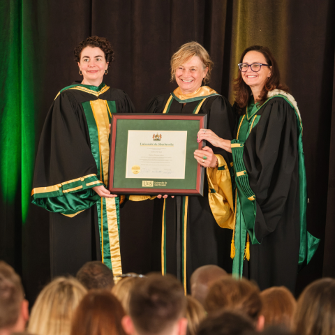 Newly minted honorary Doctor of Laws recipient Colleen M. Flood displays her degree with Marie-Pierre Robert, Dean of Sherbrooke Law, and Marie-Pierre Allard, Secretary General and Vice-Rector for Security at the Université de Sherbrooke. (Photo by Michel Caron)