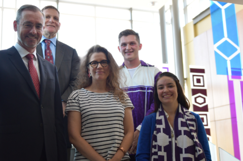 September 2018: Shelby Percival (far right), then a second-year student and speaker at the unveiling of Indigenous artwork in the Queen’s Law atrium, with then-Dean Bill Flanagan, then-Principal Daniel Woolf, artist Hannah Claus, and Brandon Maracle, Law’21. Claus’s installation, “words that are lasting,” features seven suspended wampum belt recreations that honour Indigenous legal traditions and the principles of reconciliation.