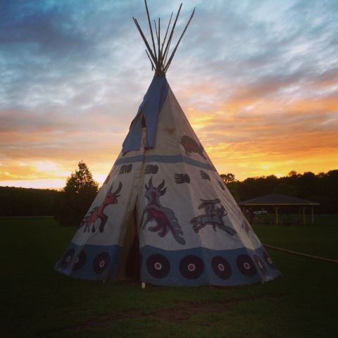 An important part of Anishinaabe legal process is the sacred fire, which is lit at the start of an Anishinaabe Law Camp to mark the beginning of the immersive learning experience. The fire lives for three nights and four days and is put to rest when the camp ends. Students may converse around the fire or simply sit in contemplation and enjoy its warmth. The sacred fire teepee above was built for a law camp hosted by the Chippewas of Nawash at Neyaashiinigmiing, Ontario. (Photo by Lindsay Borrows)