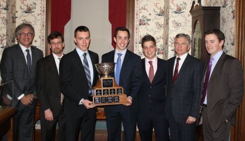 Arnup Cup winners Ben Snow (left) and Bryan Guertin hold the trophy following their victory. They are joined by (l-r) Alan H. Mark, President of The Advocates' Society and partner at Goodmans LLP; Robert Goddard, academic coach for the team and staff lawyer with the Correctional Law Project; Tony Paciocco, student coach; John M. Buhlman, secretary and treasurer of the Sopinka Cup Society and partner at WeirFoulds LLP; and Joseph Dart, academic coach for the team and lawyer at Viner, Kennedy, Federick, Allan