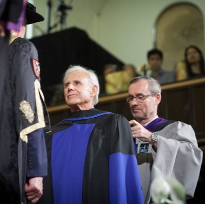 Don Bayne, Law’69, standing before Chancellor James Leech to receive an honorary LLD, is hooded by Dean Bill Flanagan. (Photo by Greg Black)