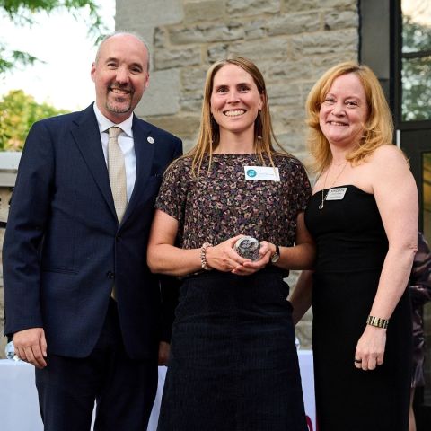 Professor Lindsay Borrows accepts her award from Mayor Bryan Paterson and Kingston Economic Development Corporation CEO Donna Gillespie at the Frontenac Club on Sept. 17.