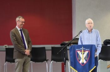 Associate Dean Stan Corbett, Law’95, addresses the audience while Dean Bill Flanagan looks on.