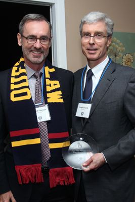 Photo by Bernard Clark. Greg Richards, Law’79 (right), accepts the H.R.S. Ryan Alumni Award from Dean Bill Flanagan at the Homecoming reception on October 18 at the University Club.