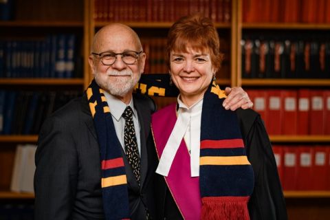 Dave Finley, Law’84, and Justice Suzanne Duncan, Law’85, show their Queen’s colours as she is sworn in as the second woman ever appointed to the Supreme Court of Yukon. (Photo by Alistair Maitland)