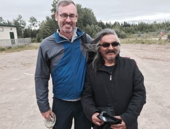 Dean Bill Flanagan visits with Ivan Sakekeep, school principal at Wapekeka First Nation, Ontario.