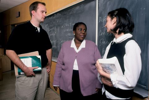 Professor King speaks with students after class in October 2000. (Photos by Bernard Clark)