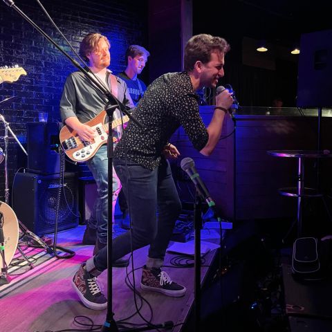 Belting out a tune at Lawlapalooza is Nathaniel Zev Winegust, Law’25, with The Reasonable Men bandmates and Law’23 classmates Liam Prymak and Stuart Gordon. 