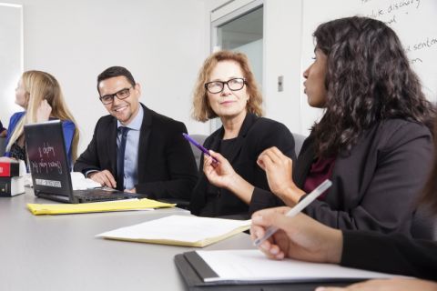 Queen’s Legal Aid students, shown discussing a case in 2018 with Review Counsel Jana Mills, Law’92, serve approximately 900 low-income clients annually, developing skills to hit the ground running as lawyers. (Photo by Greg Black)