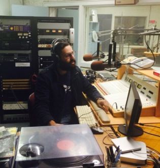 Jonathan Nehmetallah, Project Lead of Pro Bono Radio, broadcasts a show at the CFRC station at Queen’s.