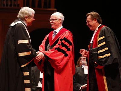 Photo courtesy of Law Society of Upper Canada. LLD honoree John Sims, QC, Law'71, is congratulated by his hooder, former Chief Justice of Ontario Roy McMurtry. Looking on is then-LSUC Treasurer Tom Conway, who presided at the Call to the Bar ceremony in Ottawa on June 23.