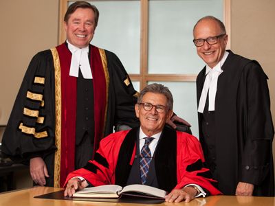 Photo by Geoff Robins. David Smye, QC, Law’70, signs the LLD register with LSUC Treasurer Thomas Conway and LSUC CEO Robert Lapper, QC, at the Call to the Bar ceremony in London on June 16.