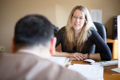 Jackie Swaisland, Law’06, works on a refugee sponsorship application with a client at her office in Toronto.