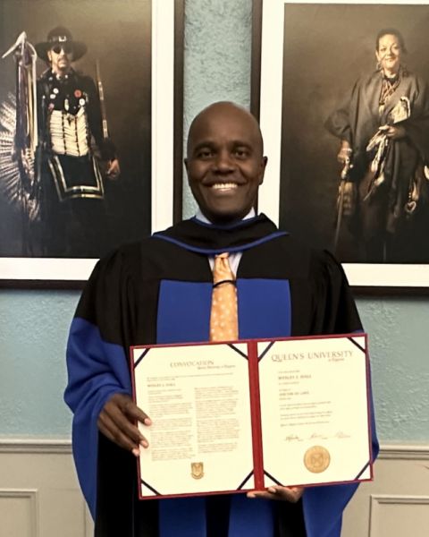 Newly minted LLD graduate Wes Hall proudly displays his honorary Doctor of Laws degree from Queen’s University in Mitchell Hall following the Convocation ceremony on Oct. 14. (Photos by Brian Truong)