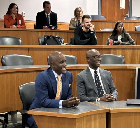Wes Hall, LLD’22, and Eme Onuoha, MBA’08, watch students pitch their ideas for social change and movement before an audience of their peers and professors during “Gaels’ Den,” an event organized by the Queen’s Law Students’ Society and the Smith MBA program. 