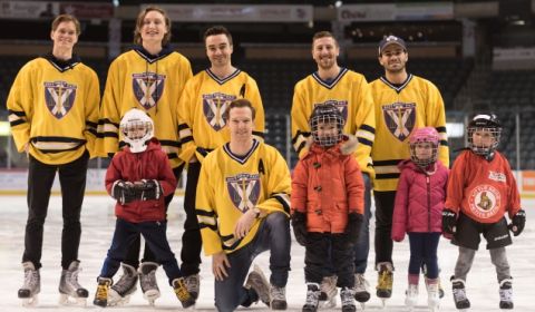 Members of the Queen’s Law men’s hockey team with Queen’s Law community children on the K-Rock Centre ice during the pre-game skate for the Winter Classic.