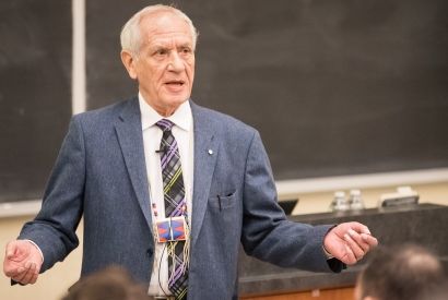 Douglas Cardinal lectures in front of a packed room in Macdonald Hall. (Photo by Andrew Van Overbeke)