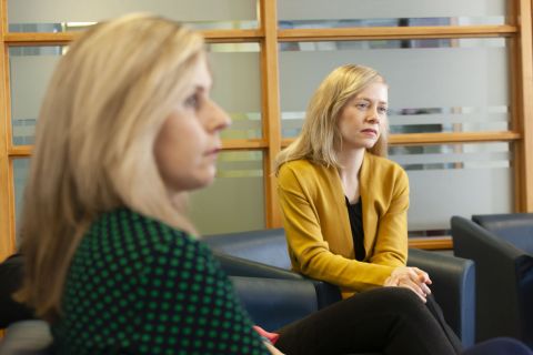 Two people site in a meeting room