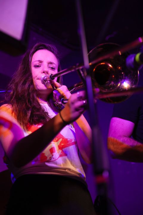 A young person plays a brass instrument