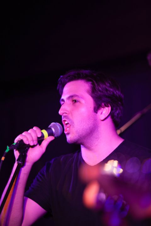 A young person sings into a microphone