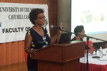 Nicole Foster, UWI Law Lecturer, speaks about international trade law as co-panelist Chantal Ononaiwu, CARICOM Trade Policy and Legal Specialist, looks on.