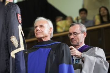 Don Bayne, Law’69, standing before Chancellor James Leech to receive an honorary LLD, is hooded by Dean Bill Flanagan. (Photo by Greg Black)
