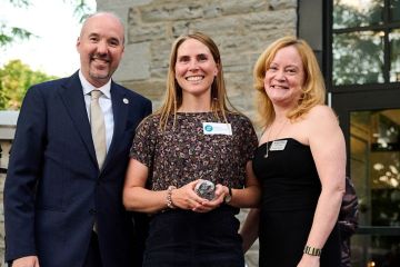 Professor Lindsay Borrows accepts her award from Mayor Bryan Paterson and Kingston Economic Development Corporation CEO Donna Gillespie at the Frontenac Club on Sept. 17.