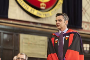 Professor Art Cockfield, Law’93, shown in his Stanford JSD gown onstage in Grant Hall at Law’s Spring Convocation 2015, has received posthumously this year’s H.R.S. Ryan Law Alumni Award of Distinction and Stanley M. Corbett Award for Teaching Excellence. 