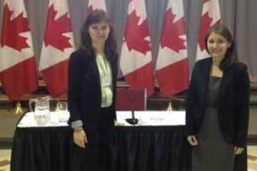 Claire Davis, Law’19, and Kate Withers, Law’17, stand before the table where Justice Malcolm Rowe sat while answering questions from MPs and senators in the University of Ottawa’s Tabaret Hall on Oct. 25.