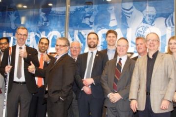 Dean Bill Flanagan (10th left) and alumni celebrate Queen’s Law in Edmonton at Rogers Place. (Photo by Grant Cree)