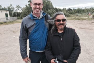 Dean Bill Flanagan visits with Ivan Sakekeep, school principal at Wapekeka First Nation, Ontario.