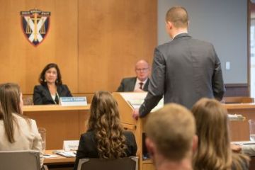 Mike Adamek, Law’17, presents an argument before a panel of OCA judges at the Grand Moot on March 10. (Photo by Andrew Van Overbeke)