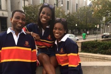 Caroline Marful, Law’23 (middle), shares a proud Queen’s moment with her father, Charles Marful (MIR’93), and sister, Maureen Marful (Comm’15), as they sport their tricolour rugby shirts on campus.