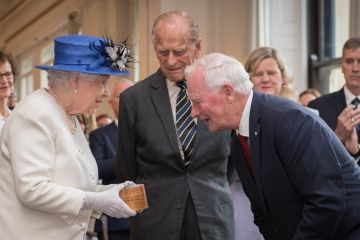 July 19, 2017: Queen Elizabeth II is presented with a gift from Canada’s Governor General David Johnston Law’66, LLD’91, as she and Prince Philip visit Canada House in London to celebrate Canada’s 150th anniversary of Confederation. (Photo courtesy of Shutterstock)