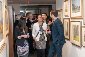 A convivial group of alumni enjoy touring the art collection housed in the head office of Shaw Communications Inc. (Photo: Patrick McAneeley)