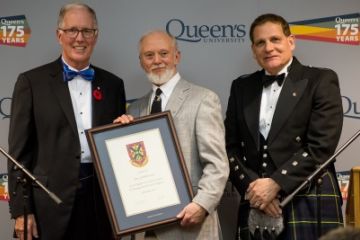 Ken Cuthbertson, Law’83, accepts his Distinguished Service Award from Chancellor Jim Leech and Principal Daniel Woolf, at the University Council Dinner in Ban Righ Hall on Nov. 5. (Photo by Garrett Elliott)